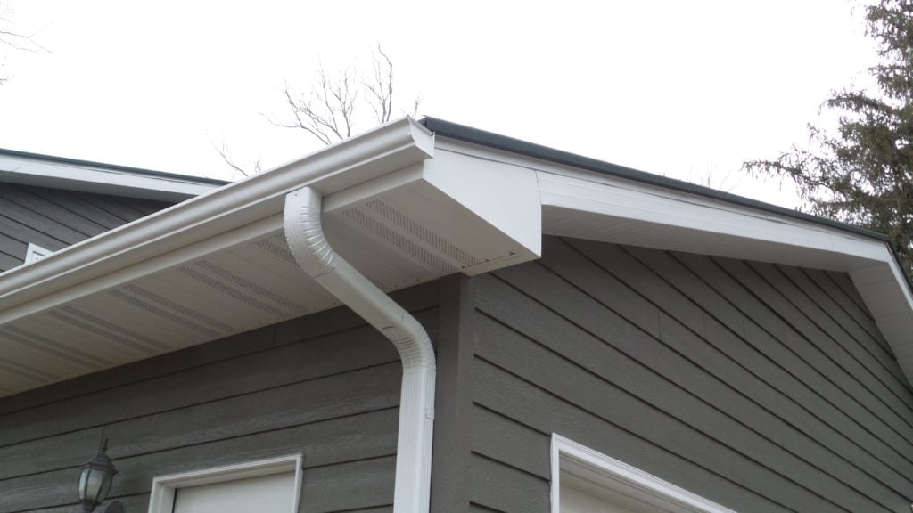 Closeup of White Downspout and Gutters