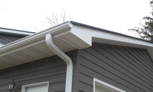 Closeup of White Downspout and Gutters